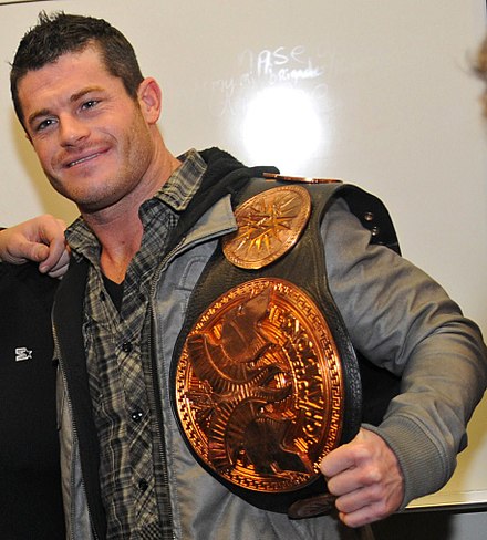 Bourne with the WWE Tag Team Championship belt in 2011