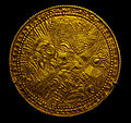 A Migration Period Germanic gold bracteate featuring a depiction of a bird, horse, and stylized head wearing a Suebian knot.