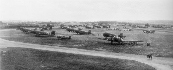 5 June 1944 photograph of C-47s of the 95th and 98th Troop Carrier Squadrons at RAF Exeter with freshly applied black/white invasion stripes to aid in