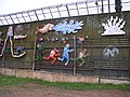 Mural on the Nogales, Sonora side of the US-Mexico border. It depicts the harsh realities of illegal immigrants travelling through the Sonoran desert. The wall itself, at this location, is constructed of Korean War-era perforated steel matting used as makeshift runways and landing strips.