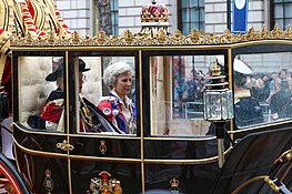 The Duke and Duchess riding in the Scottish State Coach with Vice Admiral Sir Timothy Laurence following the coronation on 6 May 2023 Coronation of Charles III and Camilla - Coronation Procession (68).jpg