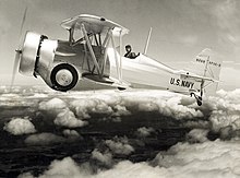 Curtiss XF11C-3 variant flying over the clouds with landing gear and tailhook retracted Curtiss XF11C-3 in Flight.jpg