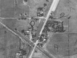 A Donnan aerial photo taken in the 1930s, showing Donnan's new main street, New Donnan Road (running diagonally from southwest to northeast). Woodard Street and Logan Street can also be clearly seen in the photo. Donnan Iowa 1930s.png