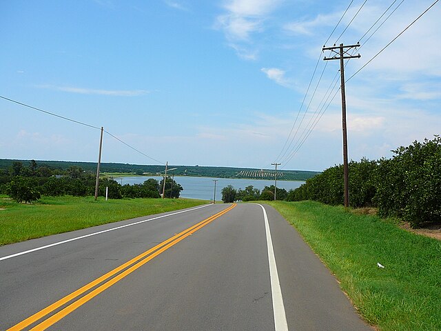 State Road 17 between Frostproof and Hillcrest Heights. Orange groves on both sides of the highway, and Lake Moody ahead.