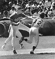 A South Alabama pitcher (left) tags out a Florida State baserunner during the 1987 NCAA Division I baseball tournament Florida State University base runner being tagged out by the opposition's pitcher - Tallahassee, Florida.jpg