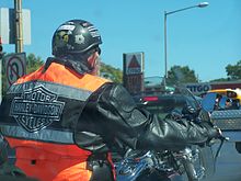 Half helmets or "skid lids" meet minimum legal requirements in the United States. Half helmet Harley-Davidson rider.jpg