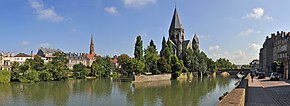 Moselle river flowing through Metz, with the church of Temple Neuf