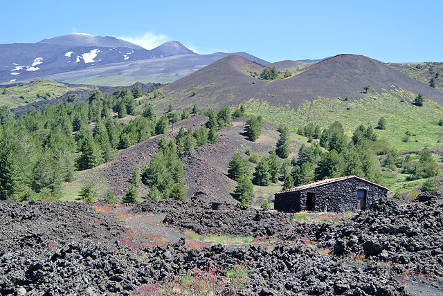 Mount Etna from the south with the smoking peak in the upper left and a lateral crater in the centre