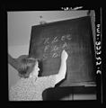 Mrs. Susan Poyce writing switching instructions on a blackboard 8d30862v.jpg