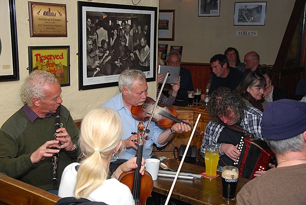 Irish musicians during a music session, among them Christy Barry (left) and James Devitt (center). Traditional music sessions are commonplace in publi