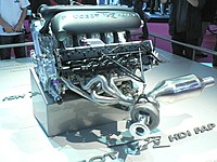 The 908's 5.5 litre twin-turbocharged diesel V12. One of the FAP particulate filters is on the right. PeugeotV12HDiFAP 3.JPG