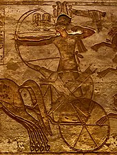 Ramses II fighting from a chariot at the Battle of Kadesh with two archers, one with the reins tied around the waist to free both hands (relief from Abu Simbel) Ramses II en Qadesh, relieve de Abu Simbel.jpg