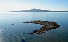 Rangitoto Island forms a backdrop to a wave-cut platform off Achilles Point, Auckland, New Zealand. Rangitoto from Achilles Point.jpg