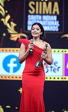 Rashmika delivering a speech following her win of the SIIMA award for Best Actress (Critics) - Kannada in 2021 Rashmika-snapped-at-SIIMA-Awards.jpg