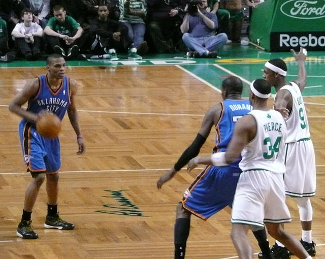Westbrook (left) looks at then-teammate Kevin Durant in the post against Boston in 2010