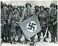 American WW2 paratroopers with captured Nazi flag in France June 1944