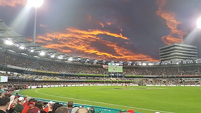 The Eastern end of The Gabba at sunset during an AFL game.jpg
