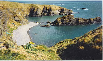 The bay at Whinnyfold in 1990, still with boats pulled up on the beach The bay at Whinnyfold.jpg