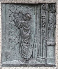 "Thomas Benet nails his protest against the Cathedral Door AD 1531". 1909 Bronze relief sculpted panel by Harry Hems showing heretical protest by Protestant martyr Thomas Benet which earned him martyrdom in 1531 at Livery Dole, Exeter. Affixed to the base of the Protestant Martyrs' Monument, Denmark Road, Exeter, Devon ThomasBenetProtestantMartyrExeter.jpg