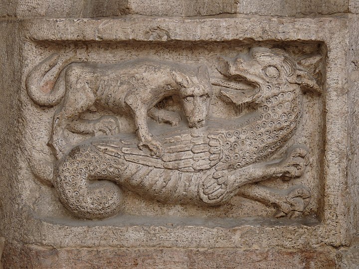 A wyvern fighting with a wolf, relief, Trento Cathedral, Italy