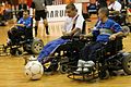 Powerchair football, also called "power soccer", uses an attachment over the footrest of a power wheelchair to bump or push the ball.