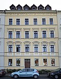 Apartment building in closed development with front garden and fence