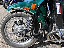 A wire wheel and pneumatic motorcycle tire on a Ural Ural-fork.jpg