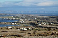 A view over Inishmore, from Dún Eochla, with Inishmaan and Cliffs of Moher in the background