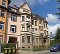 Apartment house designed as a closed development, with enclosure and front garden