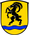 Gemeinde Hebertshausen In Gold über blauem Wellenbalken ein blau gezungter schwarzer Steinbock.