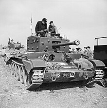 Churchill inspecting a Cromwell. The driver can be seen looking through the port to the left, with periscopes above him. Winston Churchill during the Second World War H37169.jpg