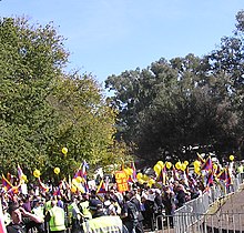 Free Tibet Protest - Canberra "China out of Tibet" sign and Flag of Tibet at Free Tibet protest at the 2008 Summer Olympics torch relay in Commonwealth Park Canberra on 24 April 2008, Tibet protest with police cordon (cropped).jpg