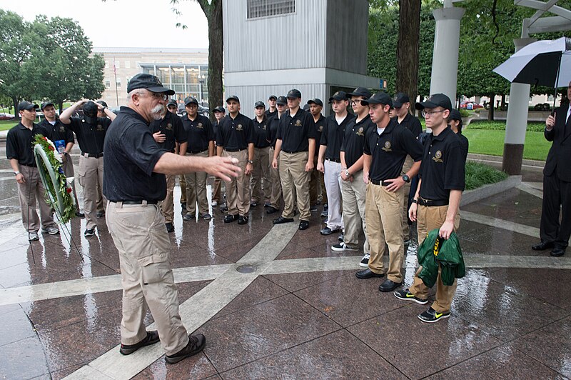 File:2015 Law Enforcement Explorers Conference explorers stand around with one holding jacket.jpg