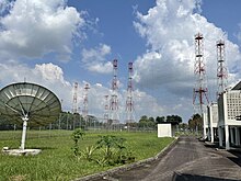 Downlink satellite dish and shortwave broadcast antenna arrays at BBC Far Eastern Relay Station BBC Kranji downlink and antennas.jpg