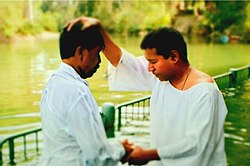 Baptism at Paravur Pond.jpg