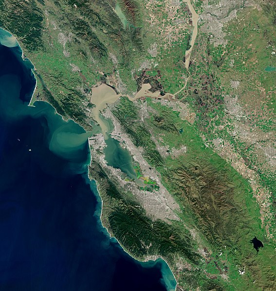 Satellite photo of the San Francisco Bay Area. The San Francisco peninsula protrudes northward. San Francisco is at its tip.