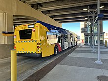 A METRO Orange Line bus boards passengers heading northbound on the freeway level of station Freeway level platform for I-35W and 46th Street Station.jpg