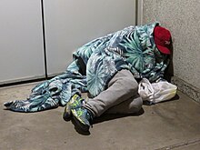 Homeless man sleeping in 3 degC (37 degF) weather at the Colorado Supreme Court Building Homeless man sleeping at the Colorado Supreme Court Building.jpg