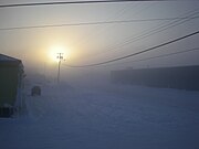 Fog caused by the burning of hydrocarbons to heat houses in the Arctic. The fog forms around communities when the temperature reaches −40 °C (−40 °F). At the time this was taken the temperature was −43 °C (−45 °F).