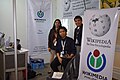 Butch Bustria and Belinda Ballesteros of Wikimedia Philippines with volunteer Felix Fajardo at the booth at the NCS event