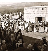 Two men dancing dabke at a village wedding, 1930s PikiWiki Israel 11009 Arab wedding.jpg