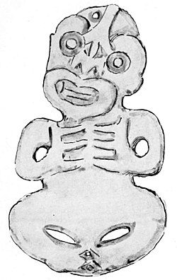 B type tiki but very unusual in that it has both hands resting over the heart. It shows only the mouth with no tongue protuding from it.