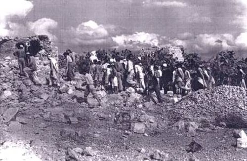 Palestinian villagers returning to the village of Qibya after the Israeli massacre