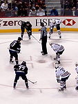 Anson Carter on the bottom left of a faceoff with the Vancouver Canucks Sedins and Carter vs Oilers.jpg