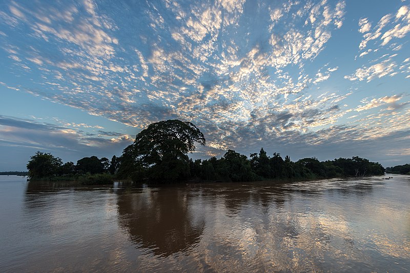 File:Silhouette of an island at sunrise with cluster of white and grey clouds in Don Det Si Phan Don Laos.jpg