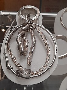 An armband and other silver items, looking highly polished and shiny