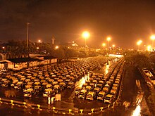 Taxicab stand outside Mumbai International Airport, mid 2000s Taxi stand by night, Chhatrapati Shivaji International Airport, Mumbai (11 September 2005).jpg