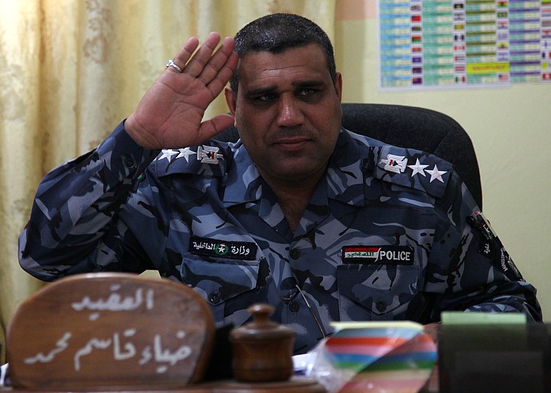 File:The Iraqi police officer in charge of the Shiba Police Training Center salutes as U.S. contractors enter his office in Basra, Iraq, May 19, 2011 110519-A-YD132-009.jpg