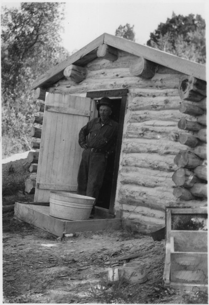 File:Tom O'Rourke in doorway to his storage cellar and milk house - NARA - 285509.tif