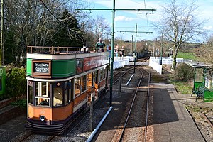 Tram waiting at Colyford, with the level crossing beyond (geograph 5719378).jpg